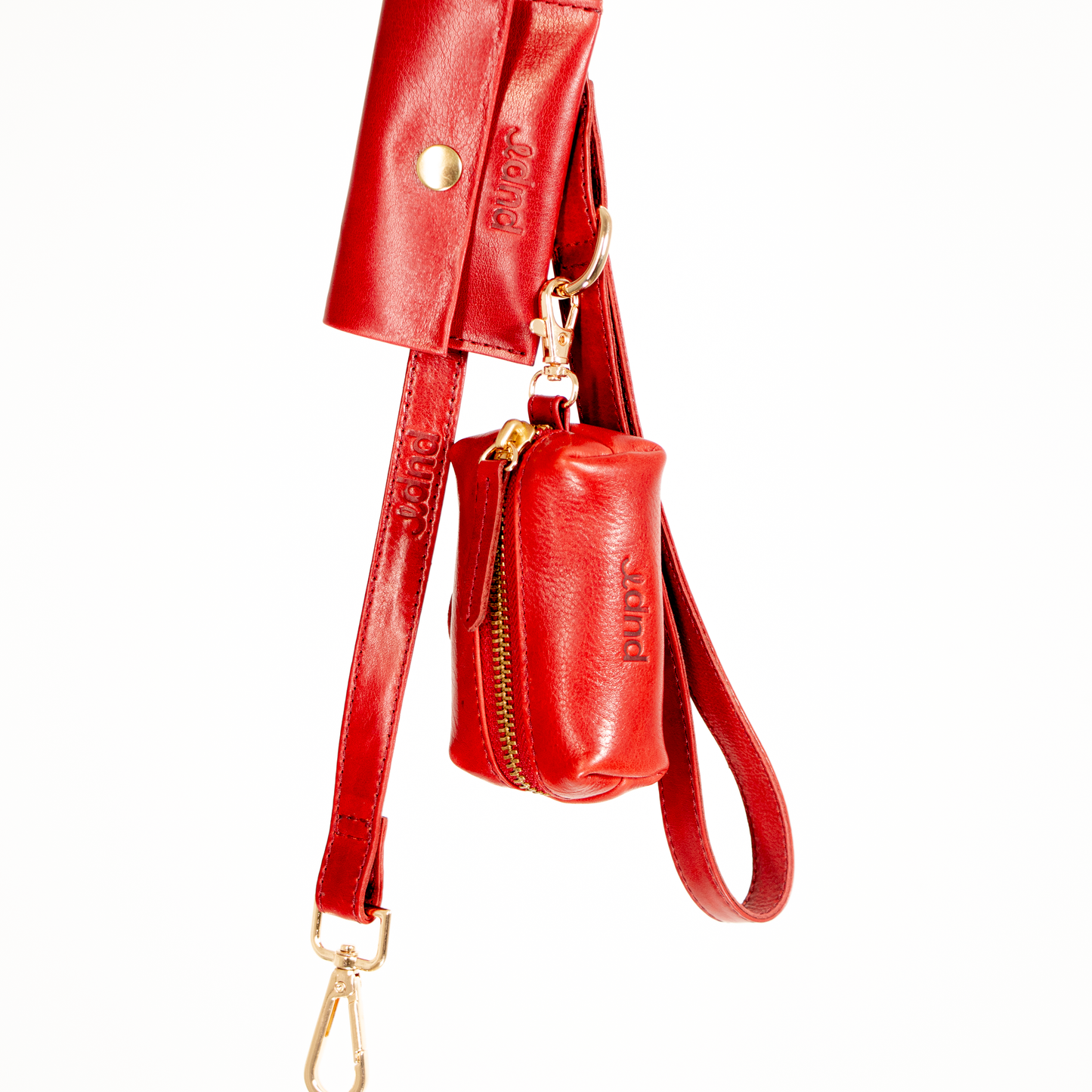 Red leather handbag with matching keychain on a white background