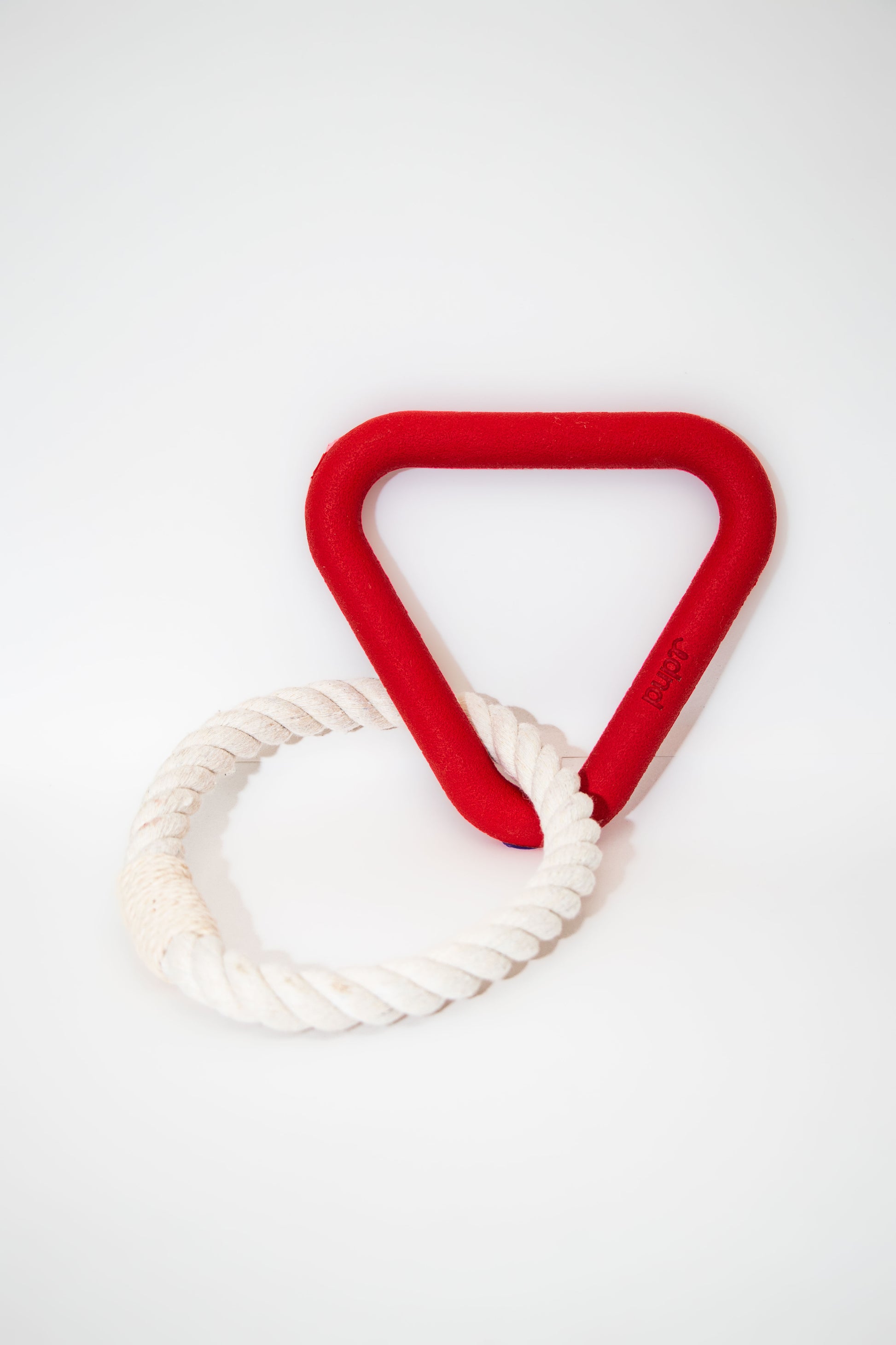 Red dog tug toy  triangular handle with white rope on a white background