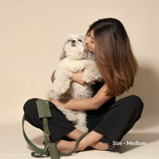 A pet parent hugging her dog sitting on the floor