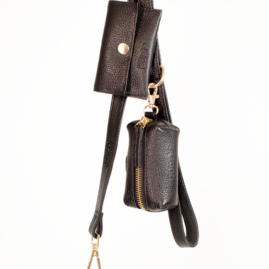 Black leather crossbody bag with a smaller attached pouch on a white background