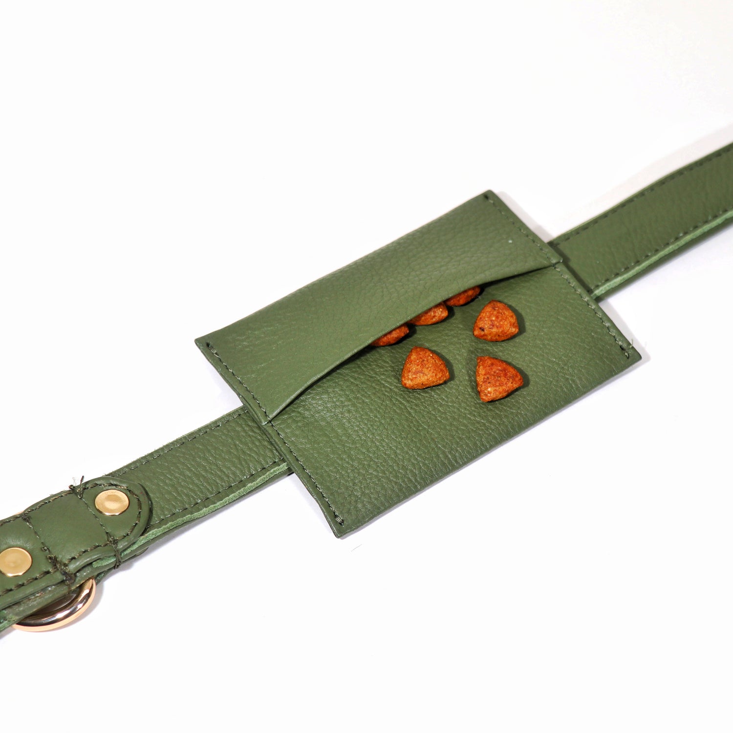 A green leather dog treat pouch with a belt, featuring a pocket with a paw print cut-out design.